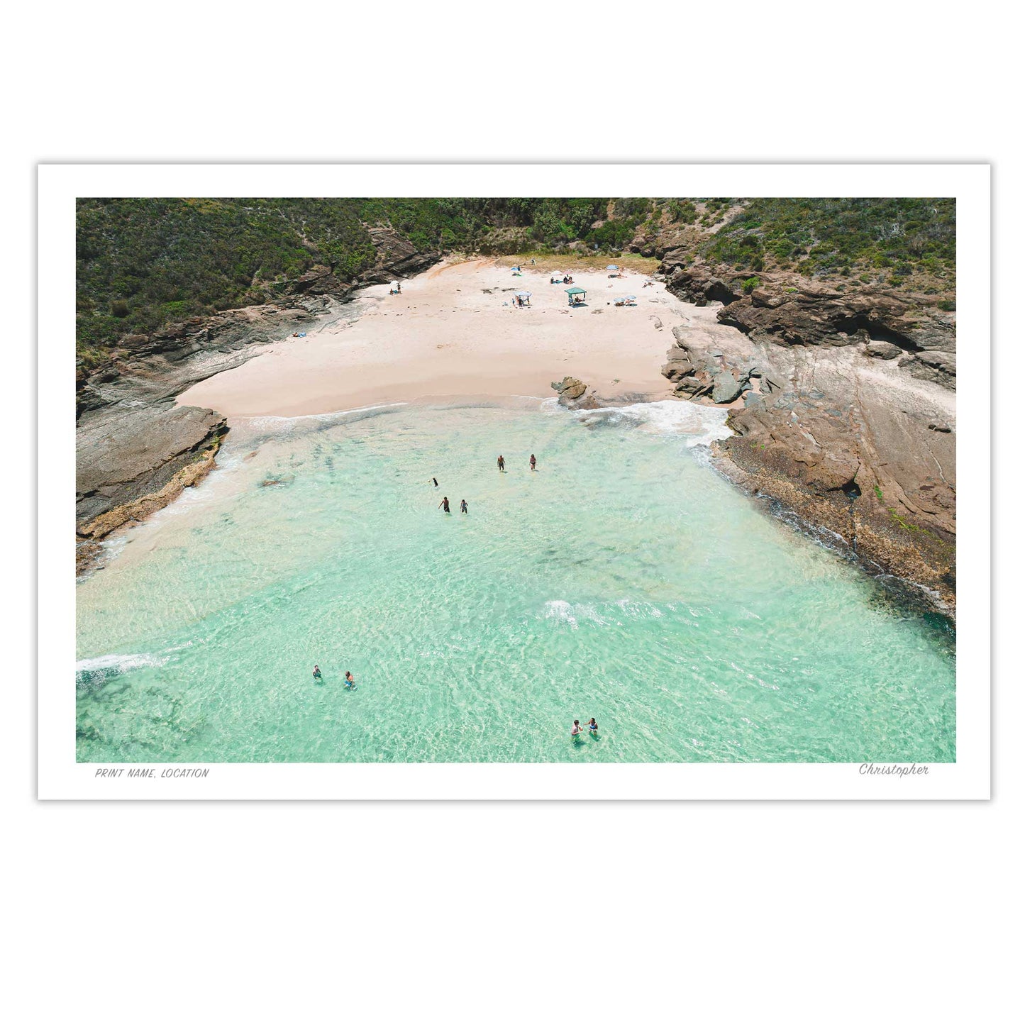 Beach scene with clear turquoise water and sandy shore, people enjoying the beach.