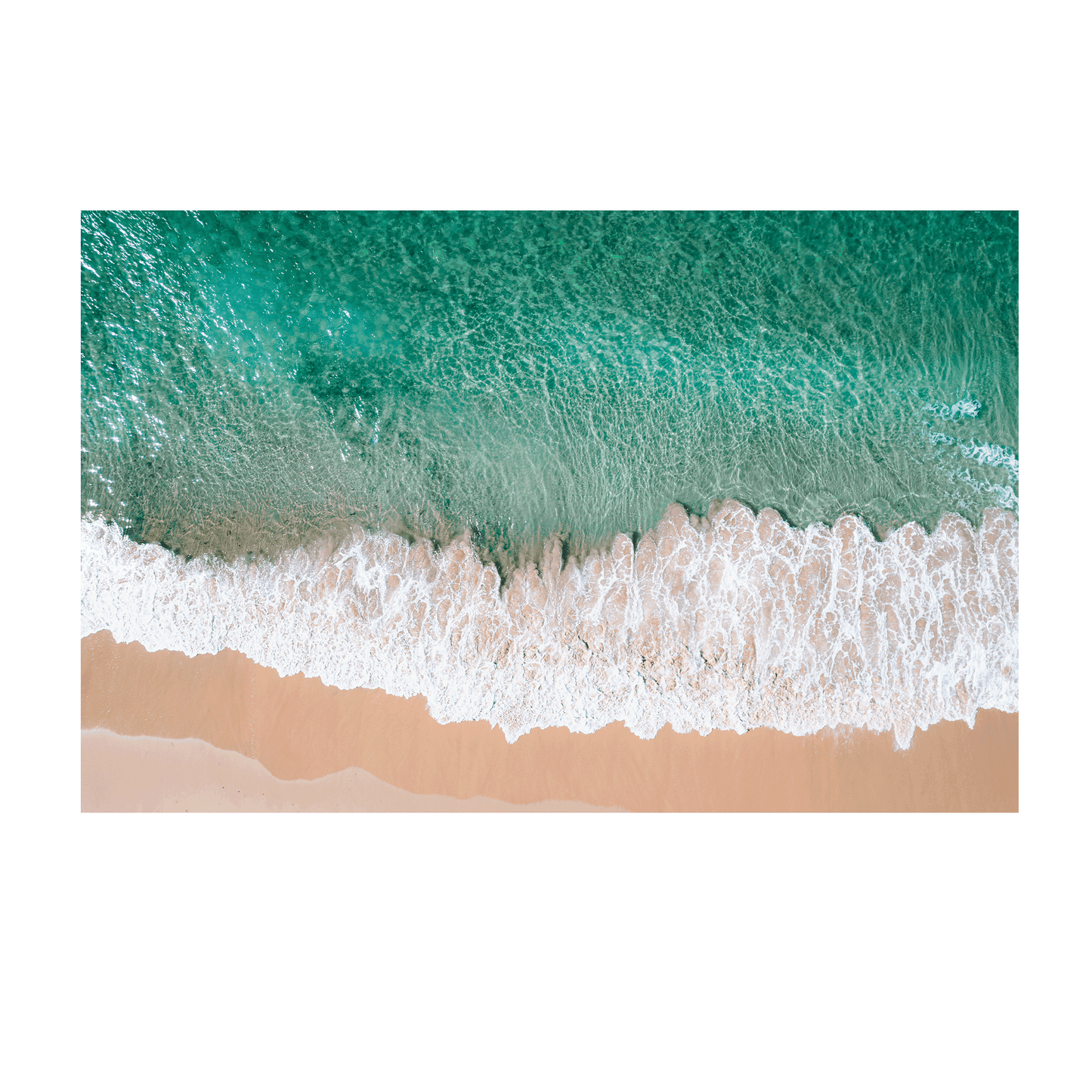 Aerial view of waves rolling onto the golden sand at Bateau Bay, NSW, creating a striking contrast between turquoise water and foamy white surf.