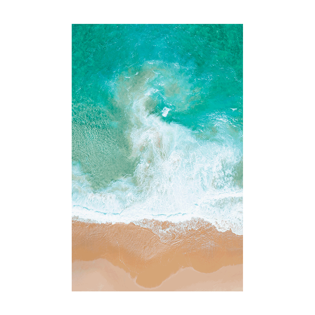 Aerial view of waves swirling over golden sands at Forresters Beach, NSW, creating a dynamic and abstract ocean scene.