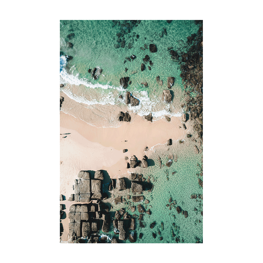 A breathtaking aerial view of Soldiers Beach, Norah Head, NSW, showcasing geometric rock formations, soft sand, and crystal-clear turquoise waters.