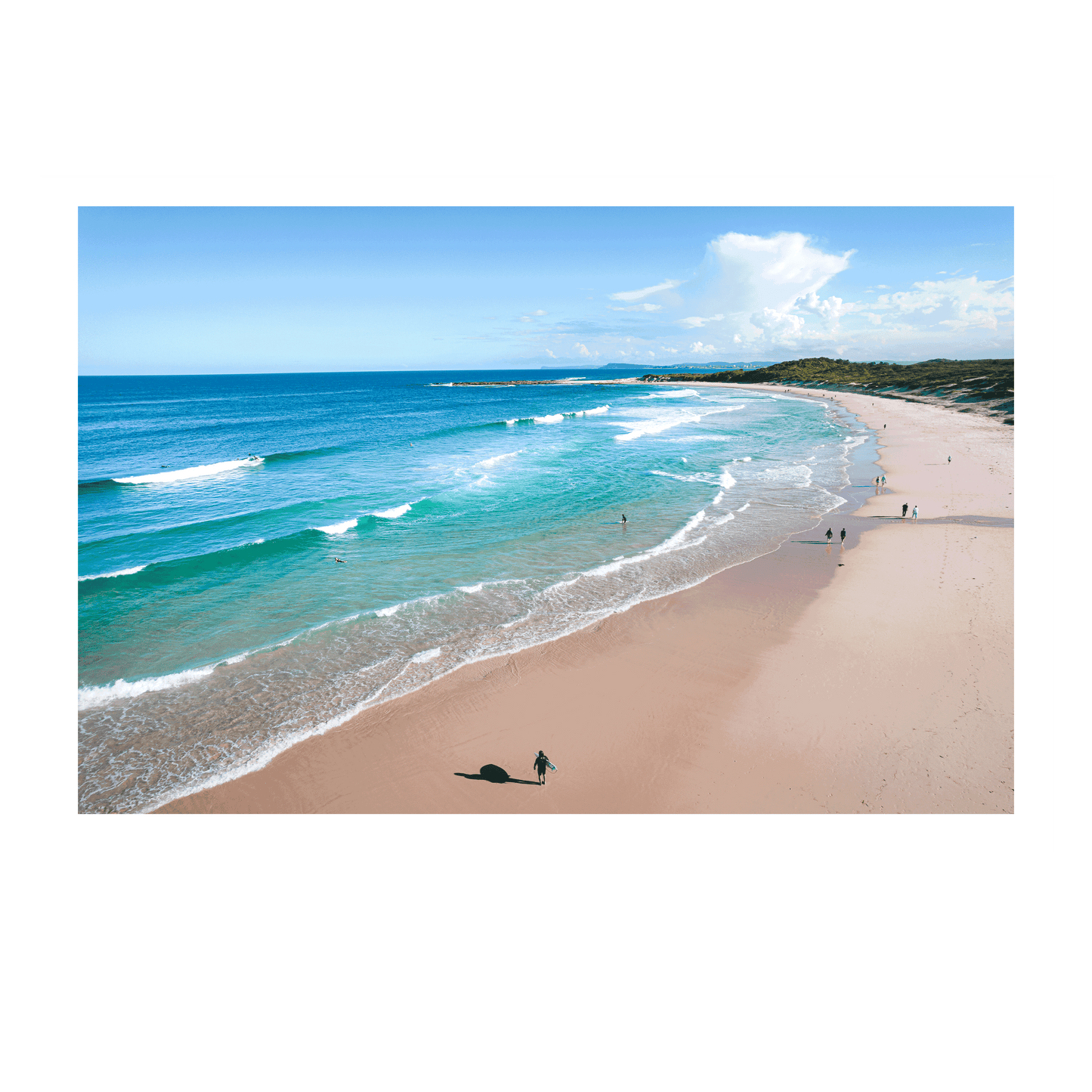 A stunning aerial view of Soldiers Beach, Norah Head, NSW, featuring rolling waves, golden sand, and beachgoers enjoying a sunny day by the sea.