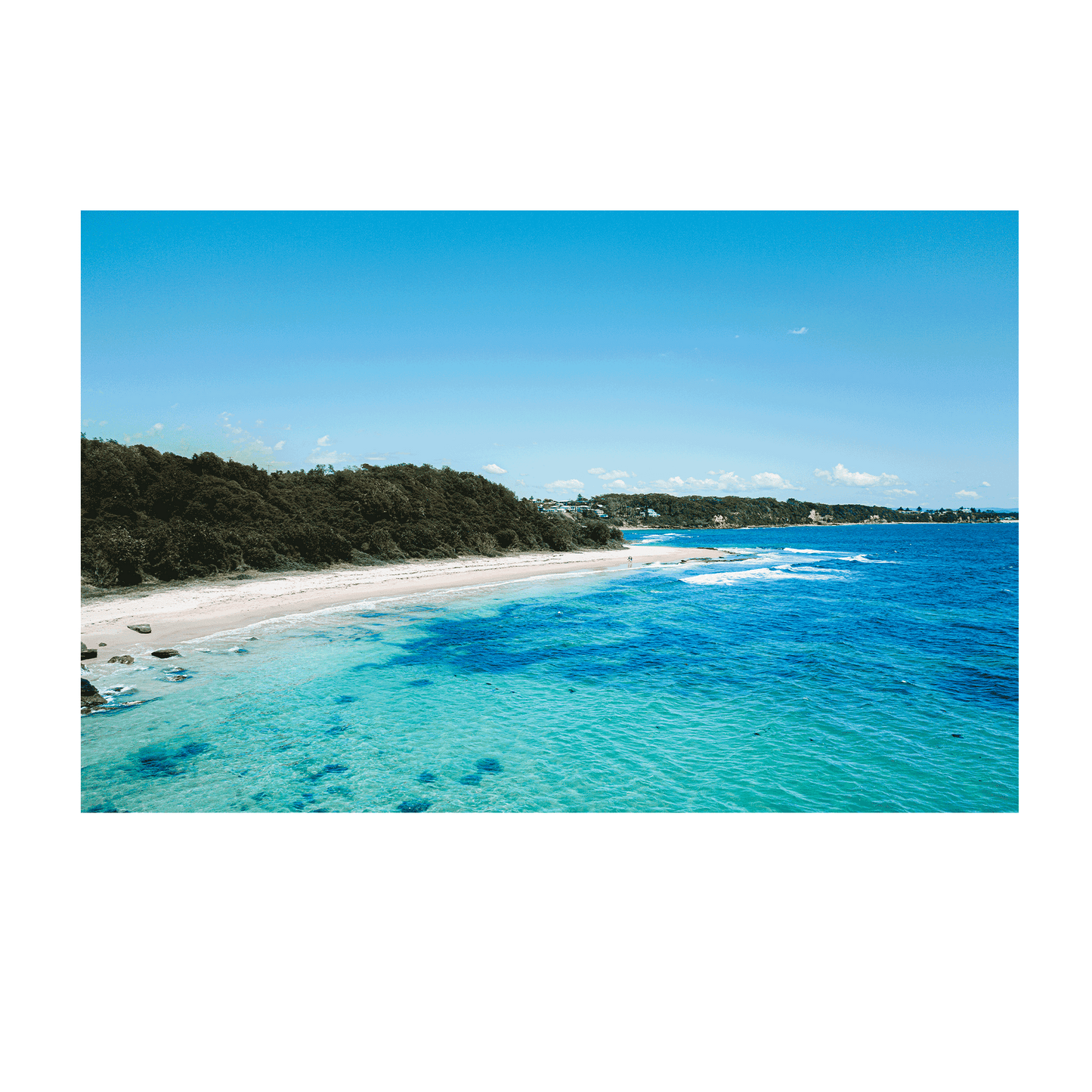 A breathtaking aerial view of Norah Head, NSW, showcasing turquoise waters, golden sand, and lush greenery.