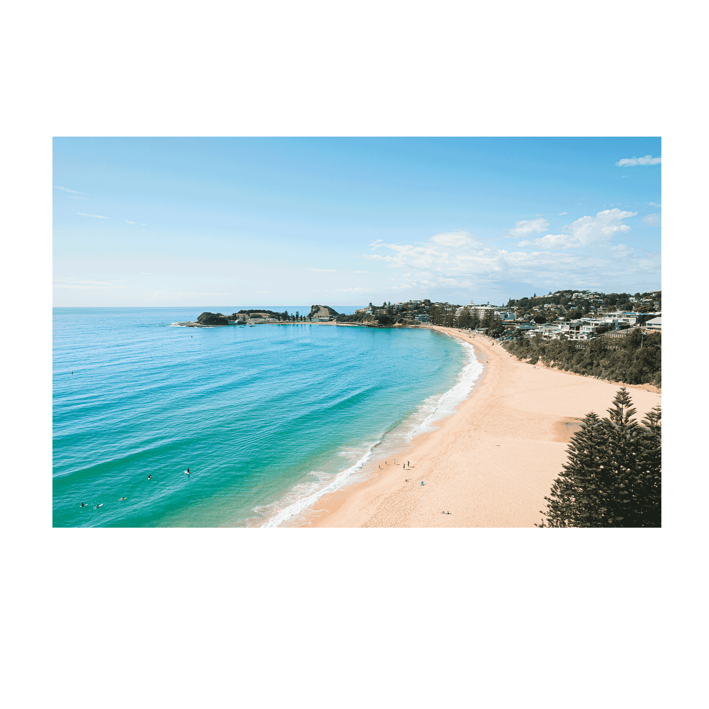 An aerial view of Terrigal Beach, NSW, showing golden sand, turquoise ocean waves, and swimmers enjoying the water on a sunny day.