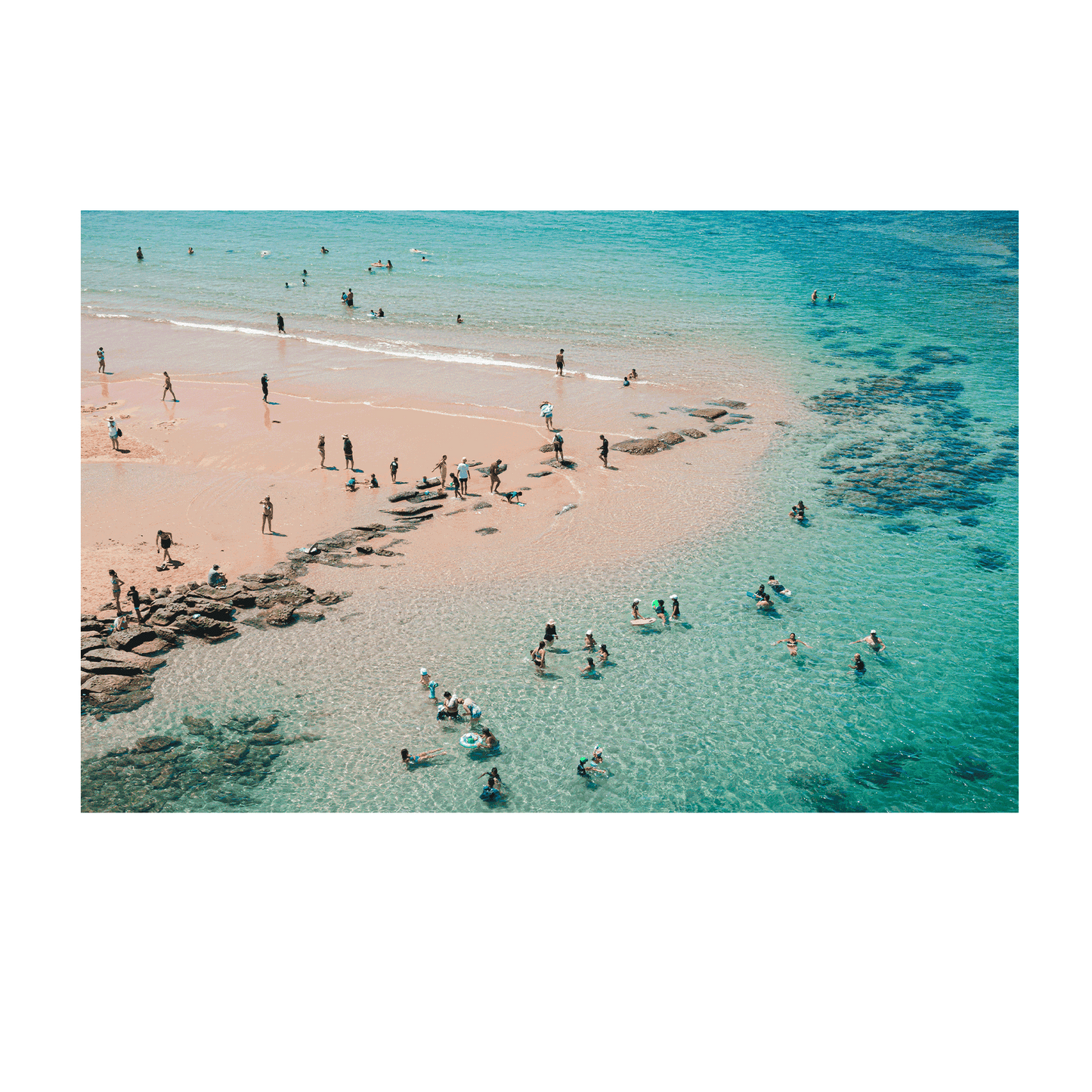Aerial view of Toowoon Bay Beach showcasing families and beachgoers enjoying the crystal-clear waters and soft golden sand. A vibrant coastal scene capturing the essence of summer and outdoor fun.