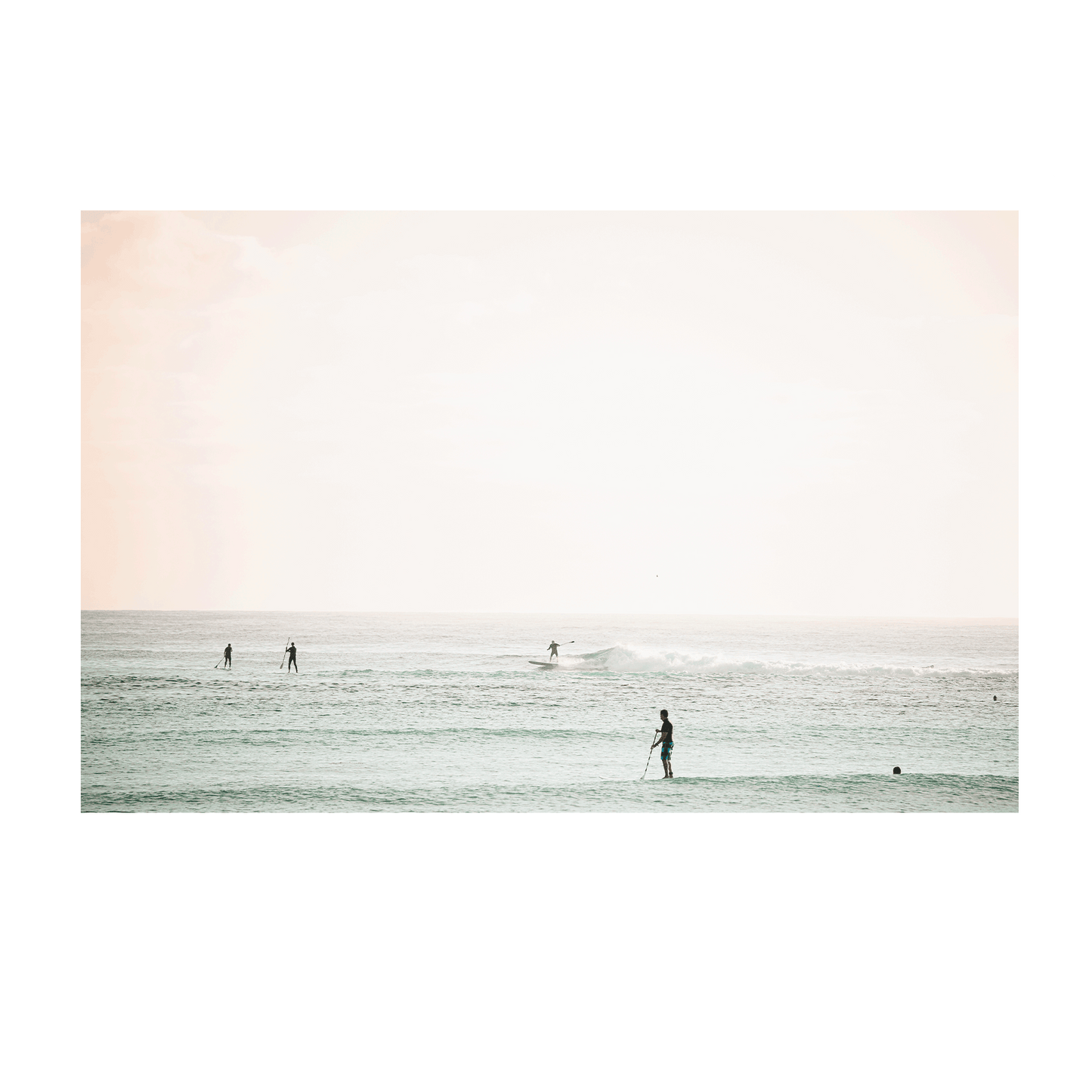 A serene coastal scene of Toowoon Bay Beach, featuring paddleboarders and surfers gliding across pastel-hued waters. A soft, minimalist ocean print perfect for adding a calming beachside aesthetic to any space.