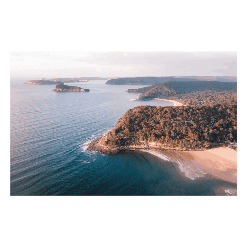 Discover the beauty of Umina Beach with Rolling Umina – a stunning aerial coastal print featuring scenic cliffs, golden sands, and deep blue ocean waters. A perfect piece for ocean lovers.