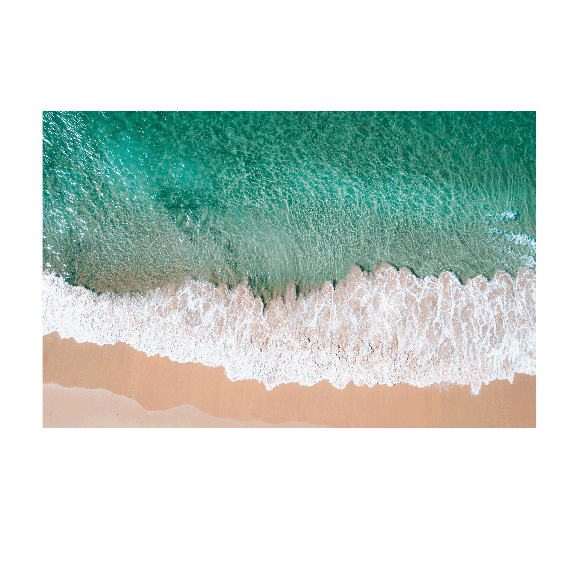 Aerial view of waves rolling onto the golden sand at Bateau Bay, NSW, creating a striking contrast between turquoise water and foamy white surf.