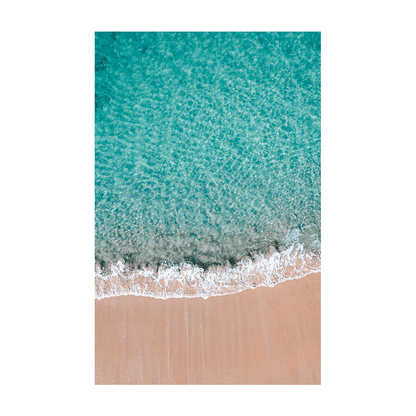 Aerial view of Blue Bay, NSW, showcasing crystal-clear turquoise waters meeting soft golden sands, creating a serene coastal scene.