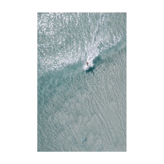 A lone surfer carves through the crystal-clear waters of Crescent Head, NSW, captured in a stunning aerial coastal print.