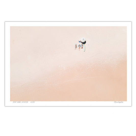 A tranquil aerial view of Point Plomer, Crescent Head, NSW, with a small group relaxing on a soft sandy beach, evoking a sense of minimalism and calm.
