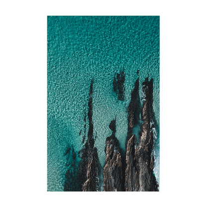 A stunning aerial coastal print of Forster, NSW, showcasing jagged rock formations emerging through clear turquoise waters.