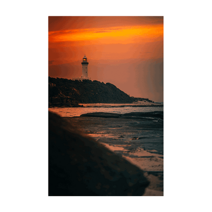 A dramatic coastal sunset at Norah Head, NSW, with a glowing magenta sky over the lighthouse and rugged coastline.