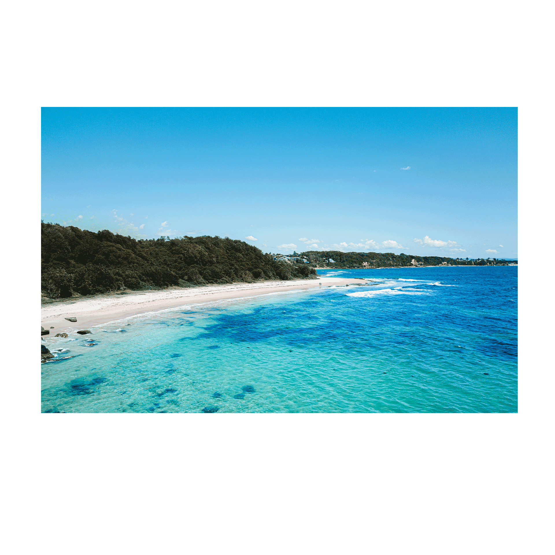 A breathtaking aerial view of Norah Head, NSW, showcasing turquoise waters, golden sand, and lush greenery.