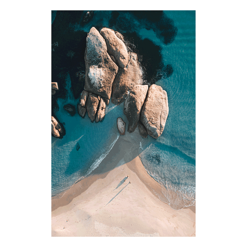 A stunning aerial coastal print of South West Rocks, NSW, featuring large rock formations meeting golden sands and deep blue ocean waters.